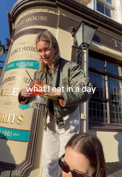 'Person enjoying a kebab while highlighting its health benefits at Neko Health in London, featured in a vlog.'