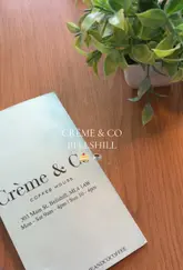 A short, casual video showcasing the interior, menu, and food items at Crème & Co in Bellshill. The video features shots of the cafe's seating area, the menu, a display of cakes, an iced latte, a loaded baked potato, and a chicken sandwich, providing a quick overview of what customers can expect.