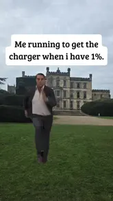 Tom Cruise running urgently with a panicked expression, looking at a smartphone with a dimming screen.