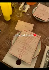 Guests enjoying large pizzas and cocktails at Circolo Popolare Manchester, featuring the iconic rustic Italian decor and hanging plants.