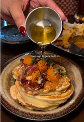 Tigermilk's Sunday brunch deal on a table, featuring a sweet dish, a savoury dish, and a hot drink.