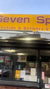 A creator reviews a variety of dishes from a Chinese takeaway called Seven Spice, eating the food inside their car. The video features close-ups of items like a spice bag, beef and black bean sauce, chicken balls, and a beef wrapper, with the creator providing commentary on the quality and taste of each dish.