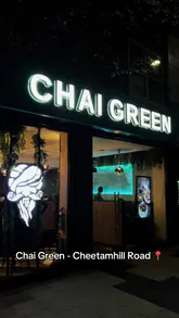 A montage-style reel showcasing the interior, menu, and various food and drink items at Chai Green, a restaurant in Manchester. The video highlights the aesthetic decor, mocktails, and a selection of dishes including kebab rolls, dynamite chicken, nihari, and desserts.