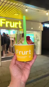 A first-person vlog showcasing the opening of a new self-serve frozen yogurt shop in Bramhall, highlighting the process of creating a custom dessert with various toppings.