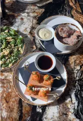Okay, assuming the image shows a Pan-Asian bottomless brunch spread at an Essex restaurant:

**Delicious Pan-Asian bottomless brunch spread with cocktails at an Essex restaurant, ideal for a special occasion. Essex food.** (122 characters)