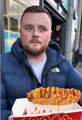 A person eating a crispy corndog at Super Asia on Parnell Street.