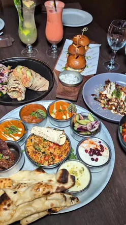 Luxurious Royal Thali with lamb seekh kebab, butter chicken, and pilau at fine-dining Indian restaurant Itihaas Birmingham.