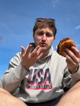 A person with a cute puppy interrupting a video review of messy smash burgers from Side Street Burger in Edinburgh.
