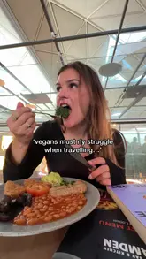 A vibrant and artfully plated vegan meal at a charming local cafe, enjoyed by a traveler discovering plant-based cuisine abroad.