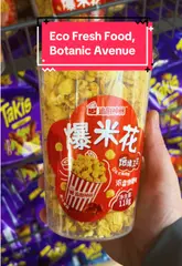 A creator provides a tour of an Asian convenience store in Northern Ireland, highlighting the wide range of imported snacks, drinks, and the presence of a hot food bar.