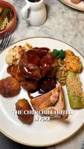 A couple visits The Churchill Hotel in York to review their Sunday roast, featuring shots of lamb and chicken roasts with traditional sides like Yorkshire puddings and gravy.
