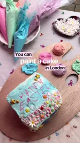 Guests painting and decorating their own Easter cakes at the Fluffy Bakery pop-up stall in Wembley Market. Perfect for kids and adults.