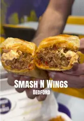 A fast-paced montage showcasing a variety of indulgent fast-food items including smash burgers, loaded fries, wings, a philly cheesesteak, mocktails, and desserts at Smash N Wings in Bedford.