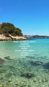 Woman meditating by the Mediterranean Sea in Mallorca, surrounded by vibrant spring flowers.