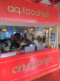 AQ Foodhall interior in Digbeth, Birmingham: a modern halal food hall with diverse global cuisines, clean aesthetics & social vibe.