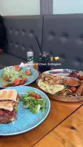 A short video showcasing a brunch visit to House of Chaii, featuring a variety of dishes including a Desi breakfast, a sandwich, and pancakes, along with specialty drinks.