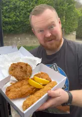 Hake, jumbo battered sausage, pea fritter, chips, and curry sauce from Smart Fish Bar, Clevedon.