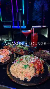 Afro-fusion dishes: smoky fried rice, spicy asun goat, and flavourful suya at Amazonia Lounge in Manchester.