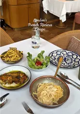 Plated modern French dishes: Caesar salad, sea bass, grilled chicken, bucatini & tarte tatin at Riviera in London.
