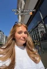 A table with Burgerism burgers and fries in Manchester, featuring the Shuffle app for restaurant savings and deals.