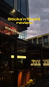 The video is a review of the new Sticks'n'Sushi restaurant in Manchester. The creator provides a walkthrough of the venue's interior and offers honest feedback on a variety of dishes, including sushi, skewers, and desserts. The video highlights the restaurant's atmosphere and confirms the halal status of the food.