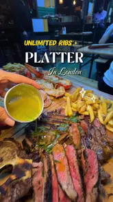 A massive T-bone steak with crispy fries and peppercorn sauce, alongside a cheese-covered lobster and grilled prawns.
