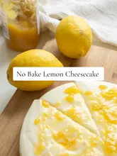 Homemade no-bake lemon cheesecake with a creamy filling, biscuit base, and a vibrant lemon curd swirl on top.