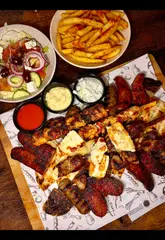 Authentic Greek food at Greek Flavours Swansea, featuring juicy grilled meats, rich moussaka, and sweet, crispy baklava.