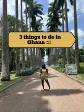 A travel-focused image featuring a creator standing on a path lined with palm trees in Ghana, with a text overlay indicating a listicle format ('3 things to do in Ghana').