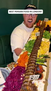 The creator visits Chef Javad, a Persian restaurant in London, to review their food after receiving recommendations. The video features close-ups of various dishes, including dips, kebabs, and rice, alongside the creator's enthusiastic commentary. It highlights the authenticity of the food, the value for money, and the impressive 1-meter kebab platter.