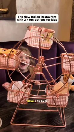 Kids at TYGA Manchester enjoying a fun Ferris wheel Naanza with butter chicken and building their own naan pizzas.
