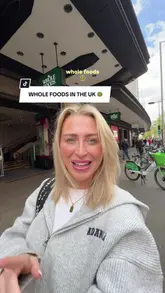 A creator tours a Whole Foods Market in London, showcasing a wide variety of prepared foods, bakery items, and grocery products available for purchase.