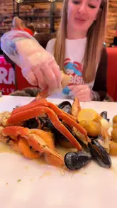 Messy seafood boil from Crabbish Liverpool with XL shrimp, blue mussels, snow crab, sausages, potatoes, corn, and eggs.