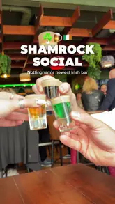 The Shamrock Social Irish bar in Nottingham, bustling with patrons enjoying Guinness, whiskey, hearty food, and live music.
