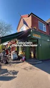 Epicerie Ludo deli in Chorlton, Manchester, displaying fresh bread, wine, and ice cream in a neighbourhood setting.