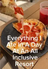 A spread of food at an all-inclusive resort in Cancun, Mexico, featuring a burger, pizza, and a tropical drink.