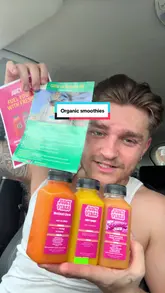 A creator reviews a selection of organic juices and sea moss gel from 'Juicy Vibes' while sitting in a car, detailing the ingredients and health benefits of each product.