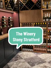 Here are a few options for your SEO alt text, depending on the focus of the image:

**Option 1 (Focus on the experience):**
"A wine flight and cheese board served at The Winery, a new wine bar on Stony Stratford high street."

**Option 2 (Focus on the venue/location):**
"Interior view of The Winery, a new cozy wine and cheese bar opening on Stony Stratford high street."

**Option 3 (Short & descriptive):**
"Wine flight and artisan cheese board on a wooden table at The Winery in Stony Stratford."

**SEO Tip:** I recommend **Option 1** as it includes the specific keywords people are likely to search for ("Wine bar", "Stony Stratford", "The Winery").