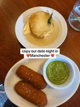 Cocktails and pizza at a trendy Manchester bar