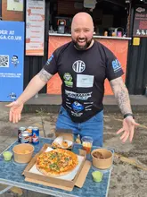 A customer enjoying a naanwich from Naanwich Club in Manchester during a food review.