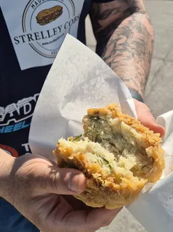 Classic crispy fish and chips with mushy peas from Chesters Chip Shop in Chesterfield, a popular British takeaway.