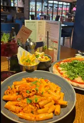 Here are a few options for your SEO alt text, all under 125 characters:

**Option 1 (Descriptive & SEO focused):**
Delicious pasta and cocktails served at a romantic, low-lit table at Prezzo Italian restaurant in Hatfield.

**Option 2 (Action/Brand focused):**
Couple enjoying a romantic date night meal with pasta and drinks at Prezzo Italian restaurant in Hatfield.

**Option 3 (Concise):**
Freshly made Italian pasta and drinks served in a cozy, ambient setting at Prezzo Italian, Hatfield. 

**SEO Tip:** I recommend **Option 1** as it includes the restaurant name, location, and the type of food, which are the most important keywords for search engines.