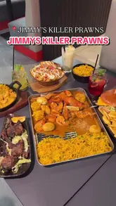 A fast-paced food review reel showcasing a variety of dishes including lamb chops, South African Malay prawns, a prawn boil, a chicken burger, loaded fries, and various mocktails/cocktails at Jimmy's Killer Prawns.