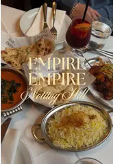 A short, punchy reel showcasing the interior, menu, and dishes at Empire Empire, an Indian restaurant in Notting Hill with a distinct disco-inspired aesthetic. The video features quick cuts between the exterior, the vinyl-decorated walls, various curries, naan, and cocktails, providing a comprehensive look at the dining experience.