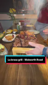 A vlog-style review of La Brasa Grill, a Latin steakhouse in London, featuring a variety of dishes including empanadas, cassava croquettes, baked plantain, and a large mixed grill platter.