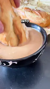 Here are a few options for your SEO alt text, depending on the focus:

**Option 1 (Descriptive & SEO-focused):**
"Toasted sandwich with cold chicken, cheese, and red onion served with a side of peppercorn sauce dip."

**Option 2 (Action-focused):**
"Dipping a toasted chicken, cheese, and red onion sandwich into a pot of peppercorn sauce."

**Option 3 (Detailed):**
"Close-up of a toasted sandwich with chicken and red onion alongside a peppercorn sauce dip and crisps."

**Tip:** Choose the one that best matches the specific visual focus of your photo (e.g., if the crisps are prominent, use option 3).