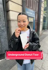 Here are a few options for your alt text, depending on the specific focus of the photo:

**Option 1 (Descriptive & SEO-focused):**
"Smiling tourist holding a box of assorted gourmet donuts during an Underground Donut Tour in Dublin, Ireland."

**Option 2 (Action-focused):**
"Woman enjoying a guided food tour experience sampling delicious donuts in Dublin city centre."

**Option 3 (Concise):**
"A tourist enjoying a donut tasting experience with the Underground Donut Tour in Dublin, Ireland."

**SEO Tip:** Including the location ("Dublin") and the activity ("Donut tour") is the best way to help your image rank for local search queries!