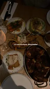 A short, music-backed montage showcasing the exterior and various dishes at Le Coq Boutique in Manchester, including roast chicken, fries, and cocktails.