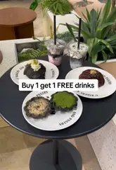 Here are a few options for your SEO alt text (all under 125 characters):

**Option 1 (Focus on the offer):**
Matcha lava tart and buy one get one free charcoal lattes at X2 Bakery and Pastry in London.

**Option 2 (Descriptive):**
Close up of a matcha lava tart and two charcoal lattes at X2 Bakery and Pastry shop in London.

**Option 3 (Keyword-heavy):**
X2 Bakery and Pastry cafe in London featuring a matcha lava tart and BOGOF charcoal latte offer.