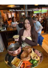 A short, punchy reel showcasing the 'Roast Cauldron Feast' at Dirty O'Sullivans in Manchester. The video features close-up shots of the roast dinner, a satisfying gravy pour, dessert, and drinks, set to music with text overlays highlighting the offer.
